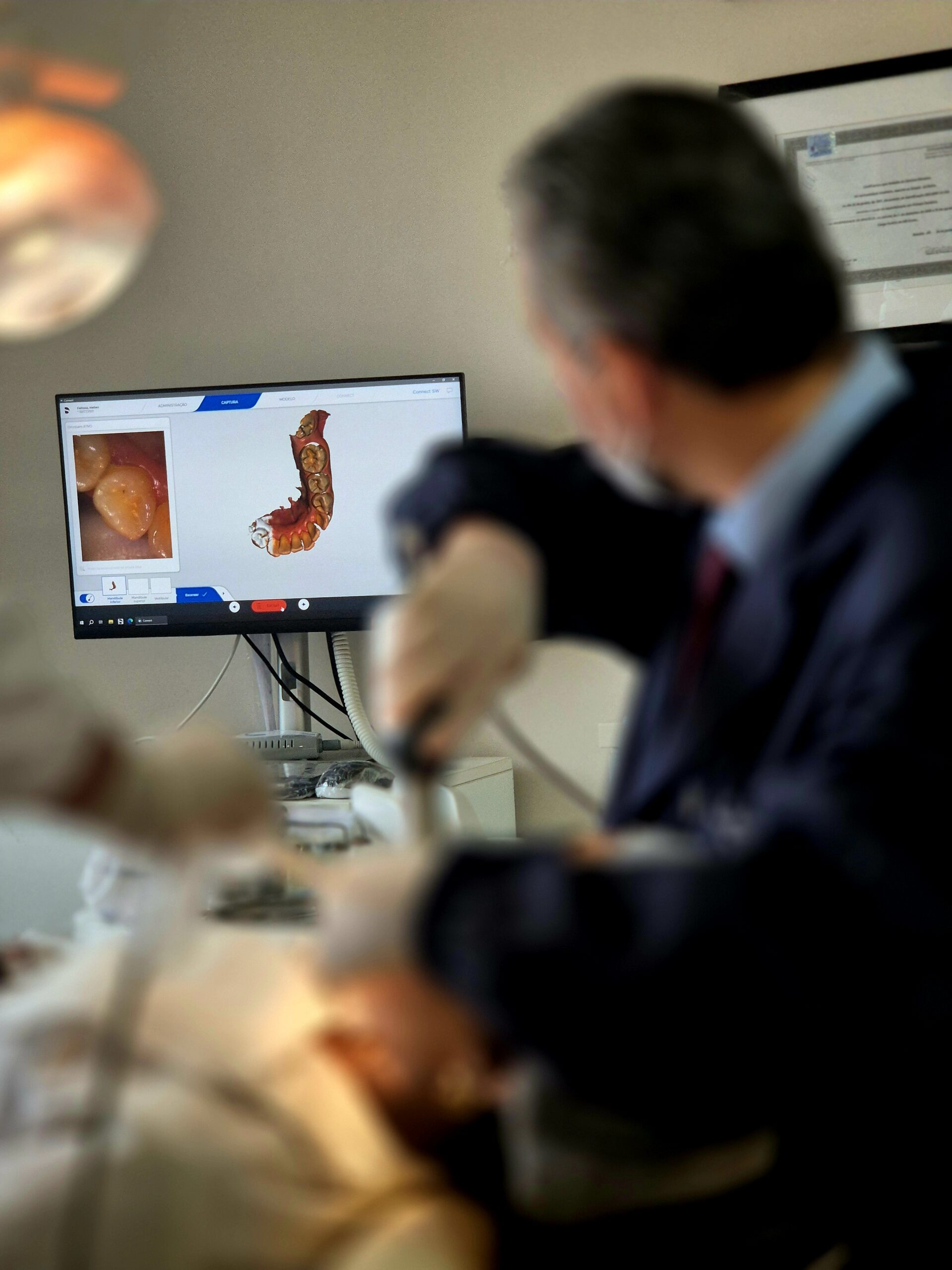 Dr. João Ribeiro utilizando scanner intraoral digital para planejamento de Invisalign na Versatta